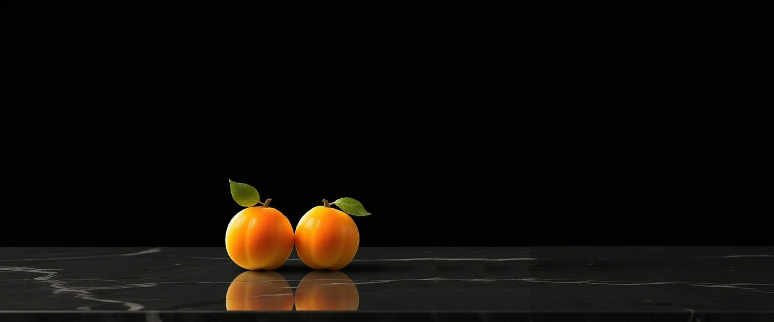 Two oubli fruits on a black marble surface with a black background